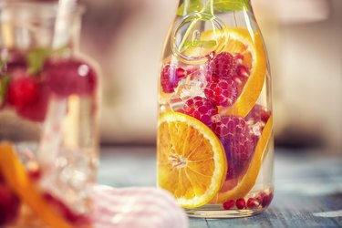 Infused water with natural sweeteners like fresh raspberries, lemon,  pomegranate and mint