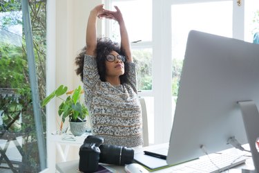 Graphic designer stretching her arms