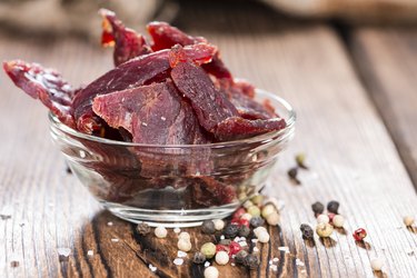 Biltong beef jerky on wooden background