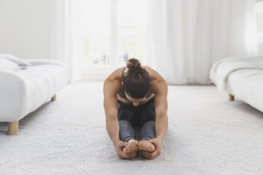 Woman sitting on the floor practicing yoga