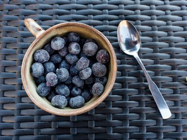 Close-Up of Blueberries in Cup on Wicker Mat