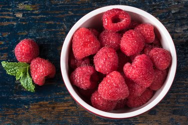 High Angle View Of Raspberries In Bowl On Table