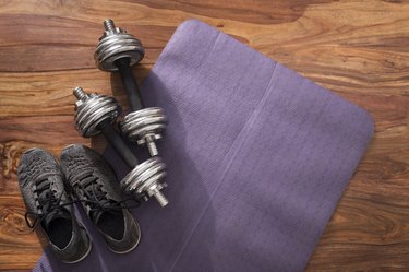 weights on an exercise mat for dumbbell exercises