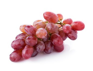 red seedless grapes isolated on white background