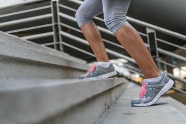 Legs and Shoes of a Jogger Running up a Staircase