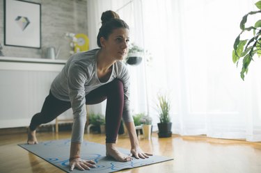 A woman practicing yoga at home