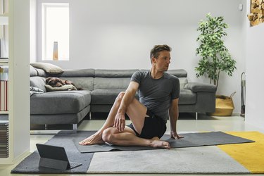Man practising yoga at home