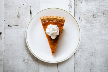 Pumpkin Pie Slice on Rustic Background