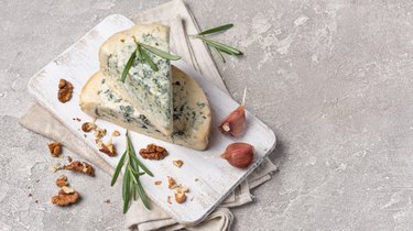 Tasty soft blue cheese with spices of rosemary and garlic