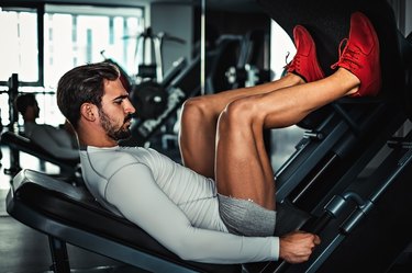 man using leg press machine