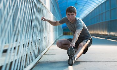 Man stretching outdoors in city