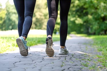 Female running feet in sport shoes