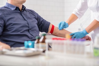 man getting his blood drawn to test for high cholesterol and learn his hyperlipidemia statistics