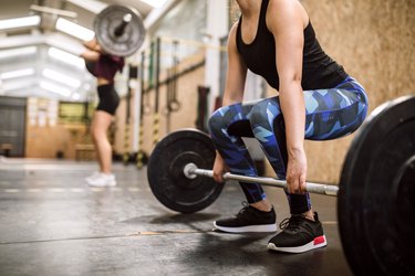 Young woman Preparing for Weightlifting