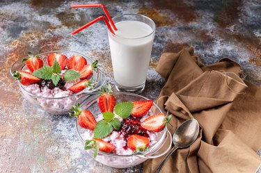 Milk products. Milk, cottage cheese, jam, yogurt with fresh strawberries and mint leaves