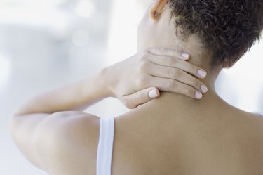 Woman rubbing sore neck