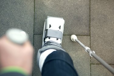 closeup of person walking with cast on foot