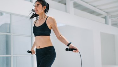 Woman doing fitness training with jump ropes