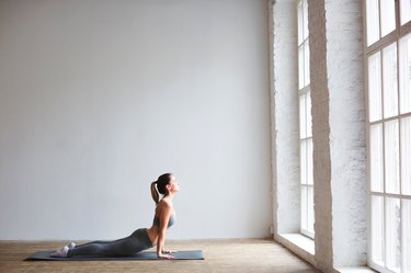 Young beautiful woman practicing the cobra pose.