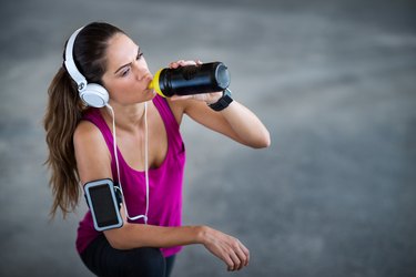 Sportswoman drinking energy drink