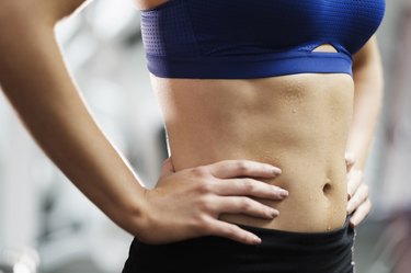 Sweating midriff of Mixed Race woman