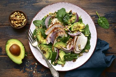 Spinach salad with grilled chicken fillet, avocado and walnuts