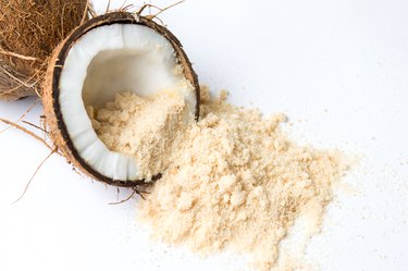 Coconut fruit and sugar on white background.