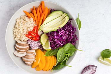 Quinoa veggie bowl with colorful vegetables and fruits