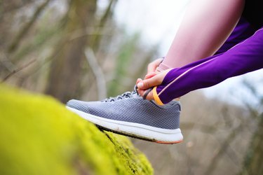 Tying laces before running in nature