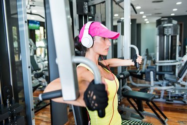 Woman training her chest muscles with a pectoral fly machine Stock