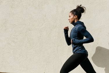 Person running outside doing exercise that increases their heart rate