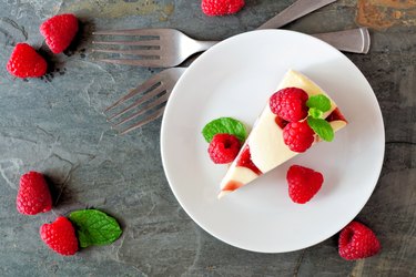 Raspberry cheesecake top view over a dark background