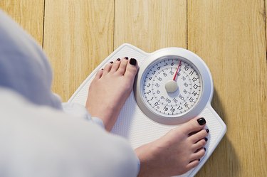 Woman standing on weight scales