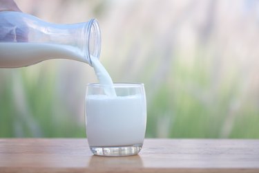 Woman pouring milk into a glass