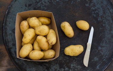 fresh ripe potatoes on table
