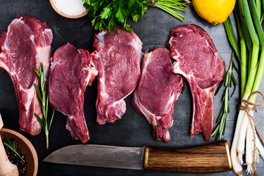 Fresh raw uncooked veal steaks with ingredients