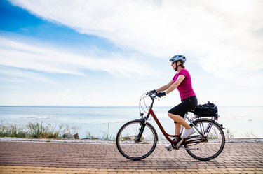 Woman riding bike at seaside