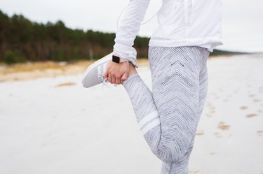 Woman stretching leg before run