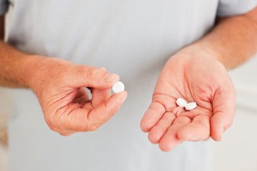 Senior man holding pills