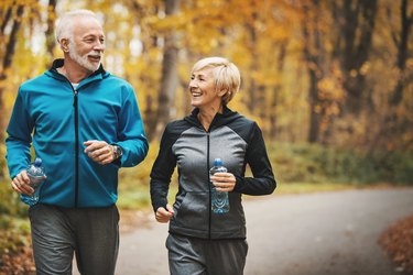 older adults jogging in a forest with energy from getting enough vitamin B
