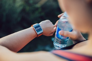 Woman checking the calories she's burned on her smartwatch