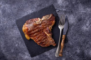 Grilled T-bone steak on slate board