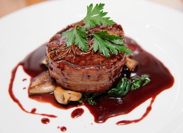 Tenderloin steak wrapped in bacon with red sauce