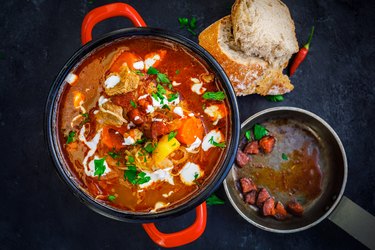 Plant-based dinner recipe for goulash soup in red pot for lunch