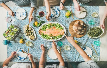 Family or friends having seafood summer dinner