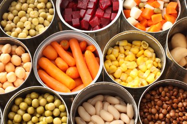 High angle view of histamine-rich cans filled with vegetables