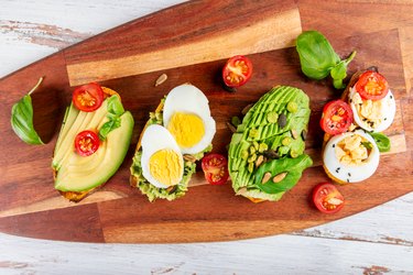 Sweet potato toasts with avocado, eggs, tomatoes and sesame seeds