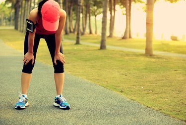 tired woman runner have a rest after running hard