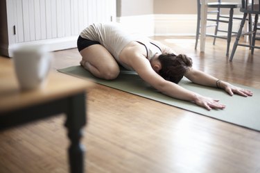 Woman practicing yoga in living room