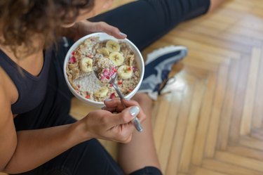 Young woman eating a oatmeal after a workout